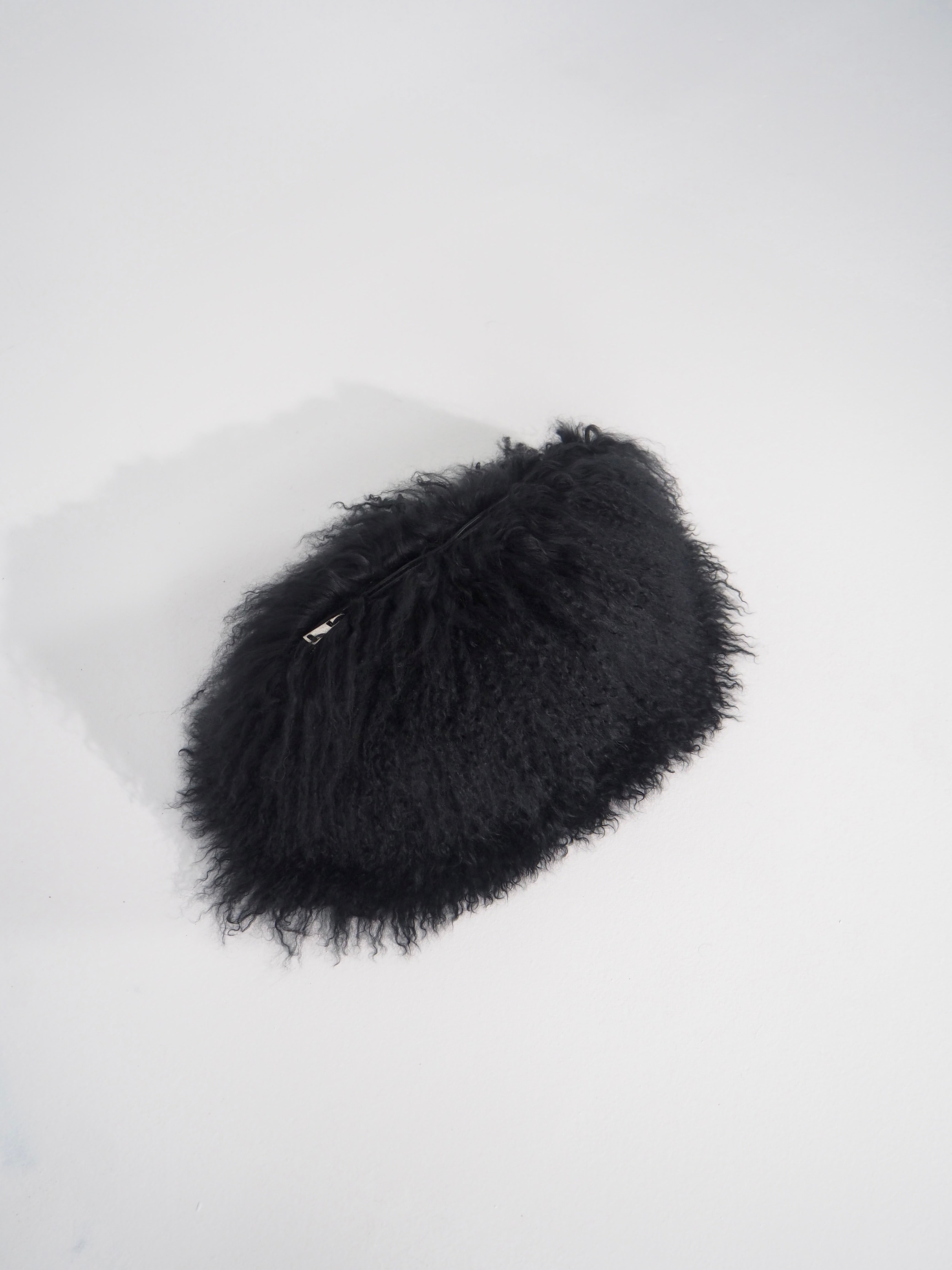 Black fluffy pouch on a white background