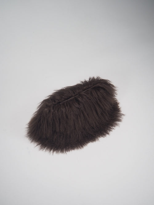 Brown fur clutch on a studio floor