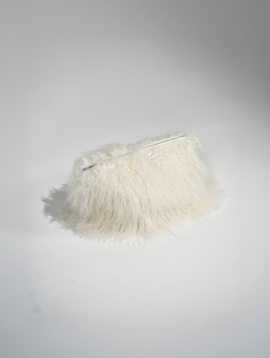 White fur clutch on studio floor