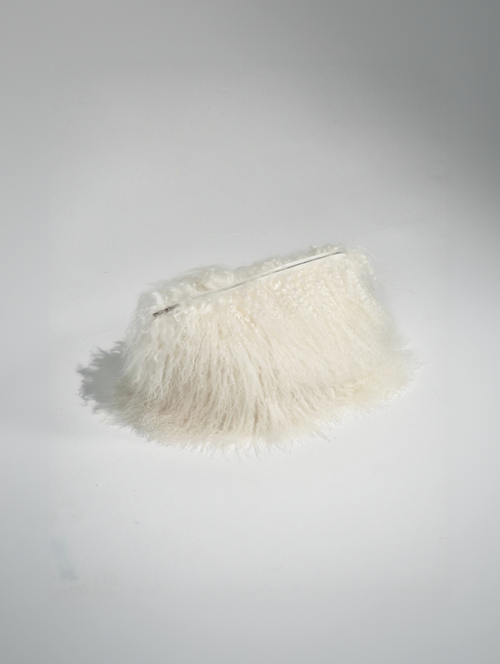 White fur clutch on studio floor